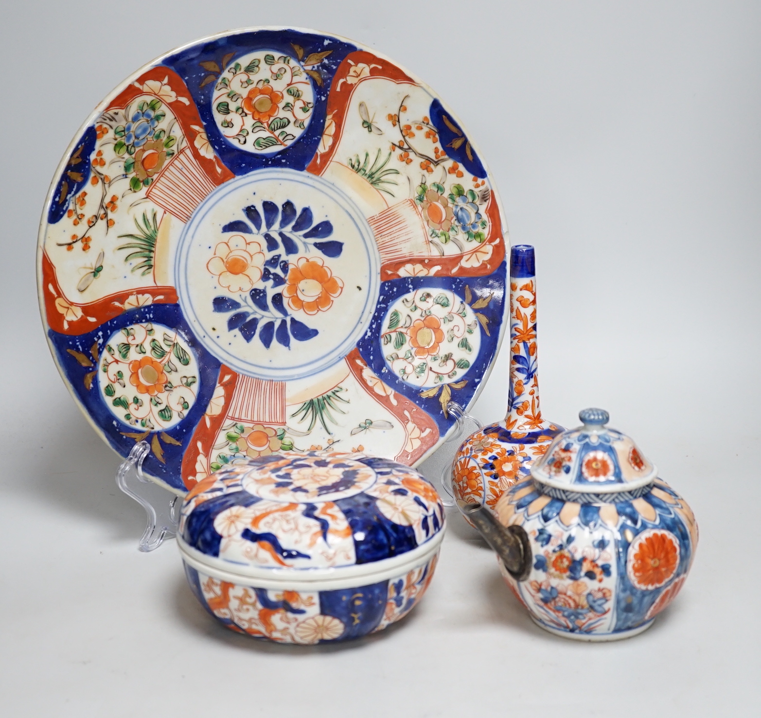 Nine Japanese Imari pieces including; a charger, lidded pot, a bowl, four small gourd vases, two lidded vases and a teapot (a.f.), charger 31cm diameter